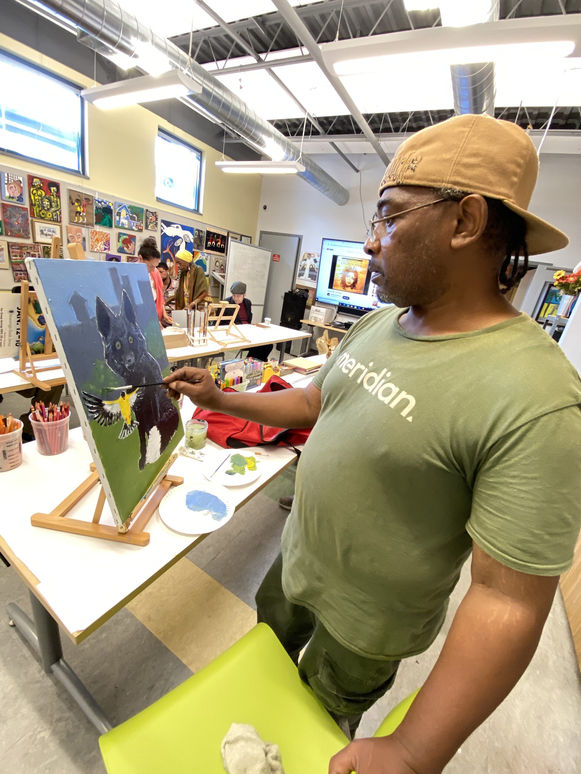 Derrick at the easel in art program