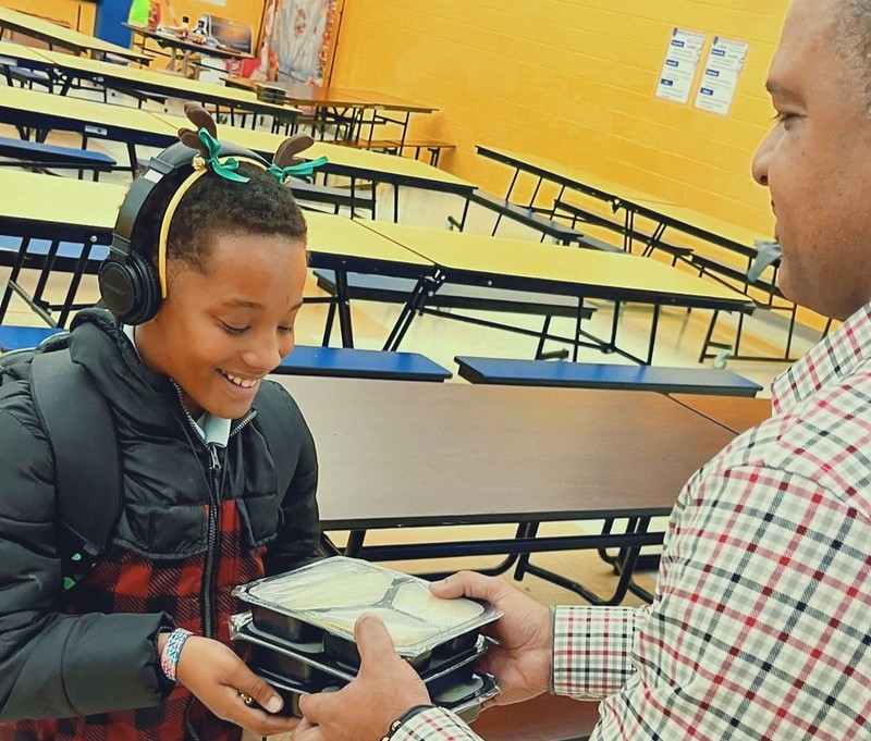 A student receives free TASK meals for his household as part of the STEAMpark after-school program at Clara Parker Intermediate School.